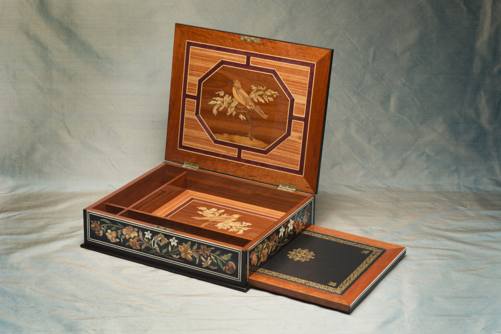 Chinoiserie marquetry in bloodwood, tulip, kingwood, yew sawn veneer. Secret compartment mechanism reveals a gilt leather writing surface.
